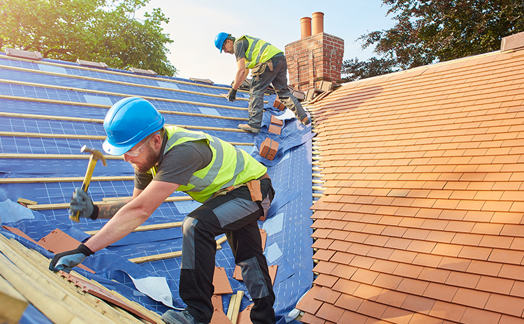 Roofing technician working on a roof